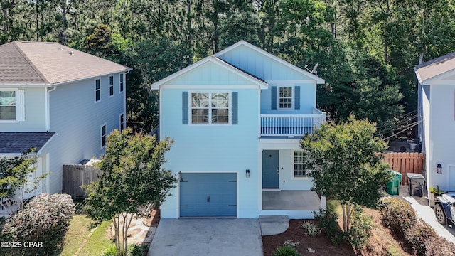 76 Mosaic Oaks Cir, Santa Rosa Beach, FL 32459 - view of front of home featuring board and batten siding, an attached garage, and concrete driveway