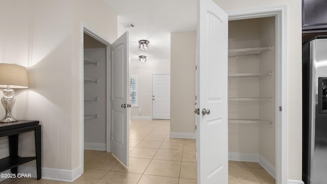 76 Mosaic Oaks Cir, Santa Rosa Beach, FL 32459 - hallway with light tile patterned flooring and baseboards