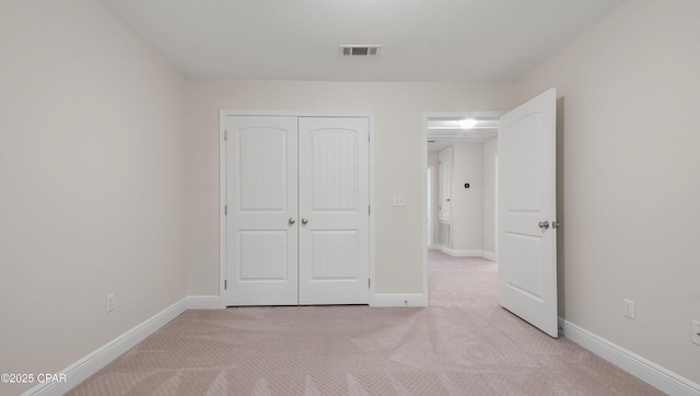 76 Mosaic Oaks Cir, Santa Rosa Beach, FL 32459 - unfurnished bedroom featuring light colored carpet, a closet, and baseboards