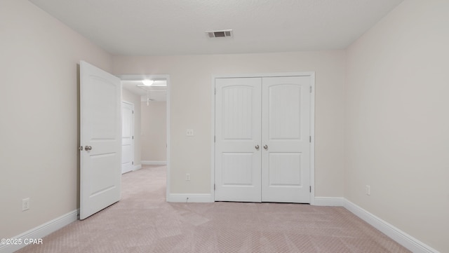 76 Mosaic Oaks Cir, Santa Rosa Beach, FL 32459 - unfurnished bedroom with a closet, light carpet, and baseboards
