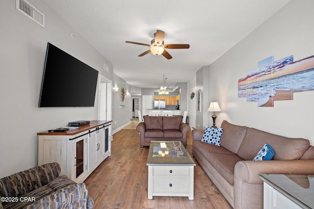14825 Front Beach Rd Unit 2210, Panama City Beach, FL 32413 - living room with wood finished floors, a ceiling fan, and baseboards