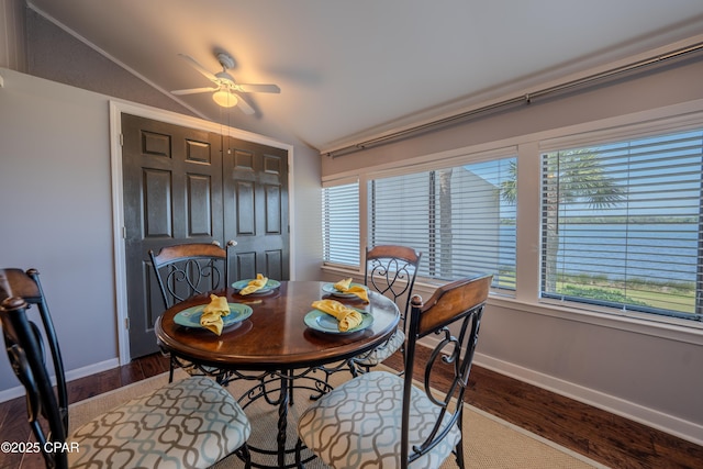 dining area with vaulted ceiling, wood finished floors, ceiling fan, and baseboards