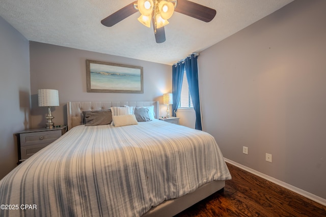 bedroom with wood finished floors, baseboards, a textured ceiling, and ceiling fan