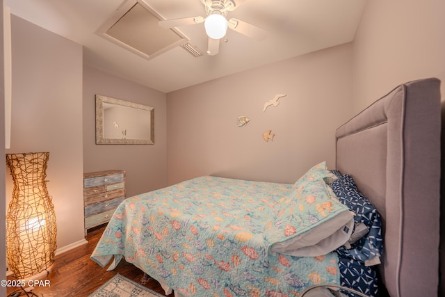 bedroom featuring attic access, dark wood-style flooring, baseboards, and ceiling fan