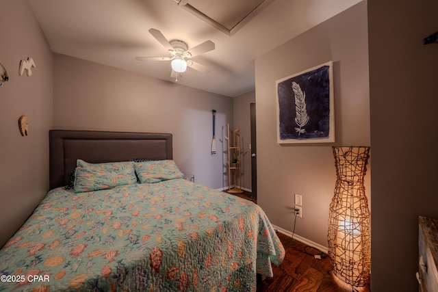 bedroom featuring wood finished floors, baseboards, and a ceiling fan