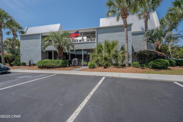 view of building exterior with uncovered parking