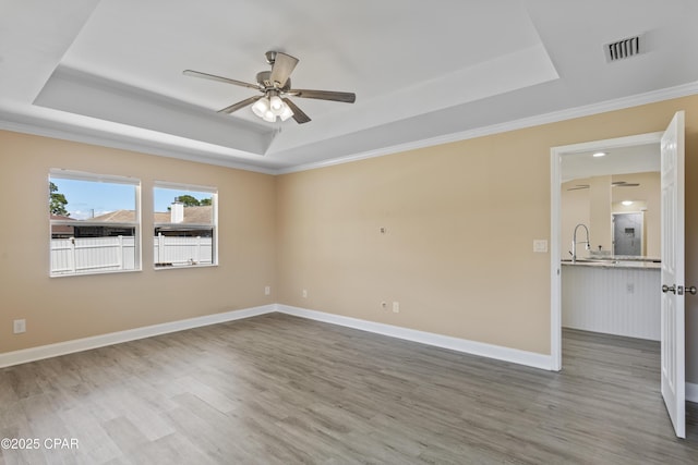 468 Forest Shore Dr, Miramar Beach, FL 32550 - spare room with a tray ceiling, ceiling fan, wood finished floors, ornamental molding, and baseboards