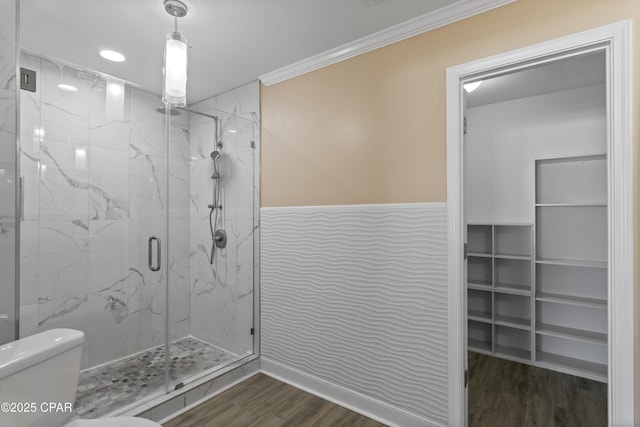 468 Forest Shore Dr, Miramar Beach, FL 32550 - full bathroom featuring a marble finish shower, wood finished floors, toilet, crown molding, and a wainscoted wall