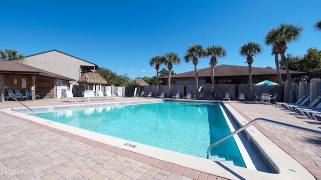 community pool with fence, a patio, and a gazebo