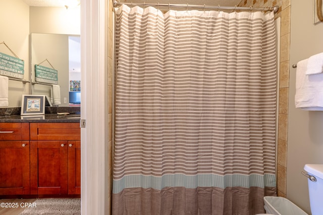 bathroom with vanity, toilet, and a shower with shower curtain