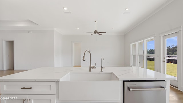 kitchen with a sink, ornamental molding, dishwasher, light stone counters, and ceiling fan