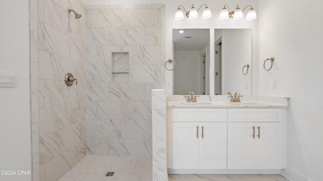 full bath with tiled shower and double vanity