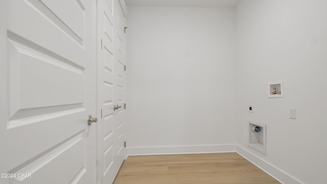 laundry area featuring electric dryer hookup, light wood-style floors, washer hookup, and baseboards