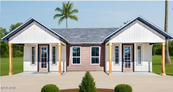 8600 Houston St, Panama City Beach, FL 32408 - view of front facade featuring a shingled roof