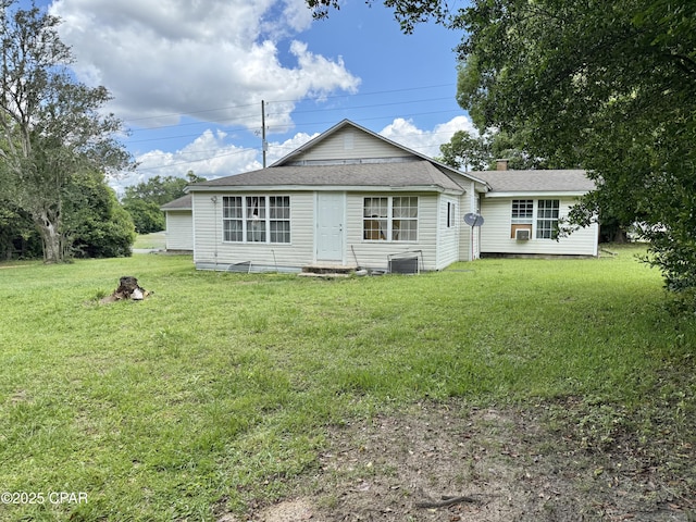 1331 Jackson Ave, Chipley, FL 32428 - back of property with a lawn, a shingled roof, central AC unit, and a chimney