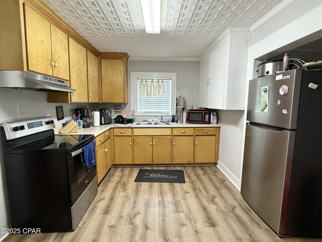 1331 Jackson Ave, Chipley, FL 32428 - kitchen featuring appliances with stainless steel finishes, under cabinet range hood, an ornate ceiling, light wood-style flooring, and light countertops