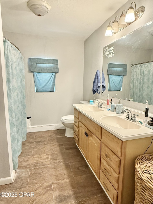 1331 Jackson Ave, Chipley, FL 32428 - bathroom featuring double vanity, toilet, and a shower with curtain