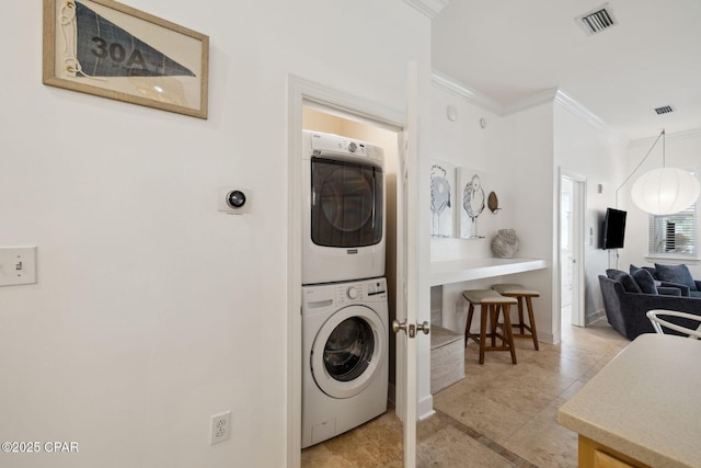 231 Somerset Bridge Rd Unit 1103, Santa Rosa Beach, FL 32459 - laundry area with stacked washer and clothes dryer, crown molding, and light tile patterned floors