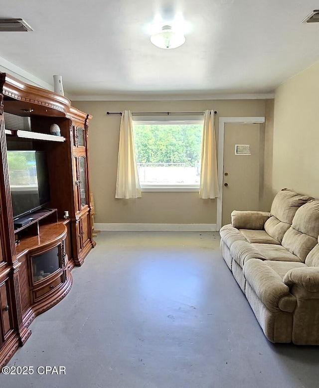 9541 Stauber Ln, Youngstown, FL 32466 - living area with finished concrete flooring and baseboards
