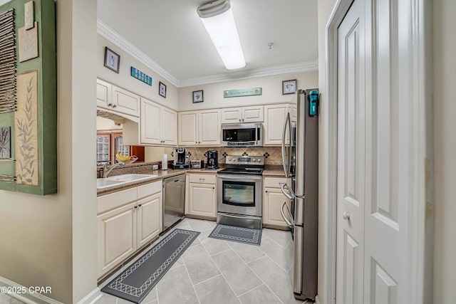 kitchen with stainless steel appliances, a sink, ornamental molding, and tasteful backsplash