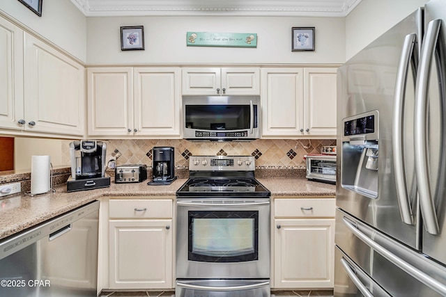 kitchen with stainless steel appliances, backsplash, light countertops, and crown molding