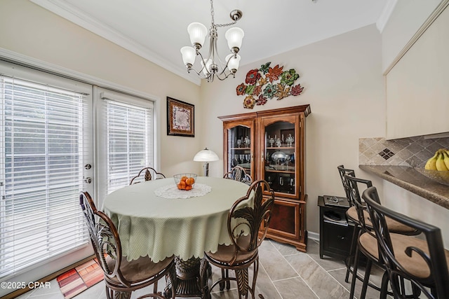 dining room featuring a chandelier, ornamental molding, and light tile patterned flooring