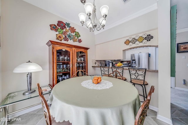 dining room with a chandelier, ornamental molding, and baseboards