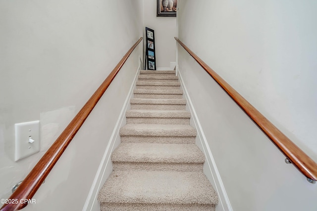 staircase with carpet floors and baseboards