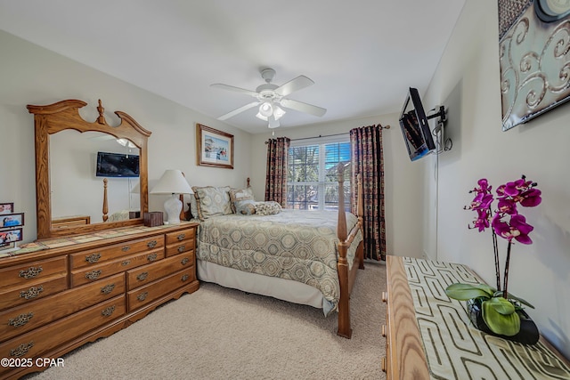 bedroom with light carpet and a ceiling fan