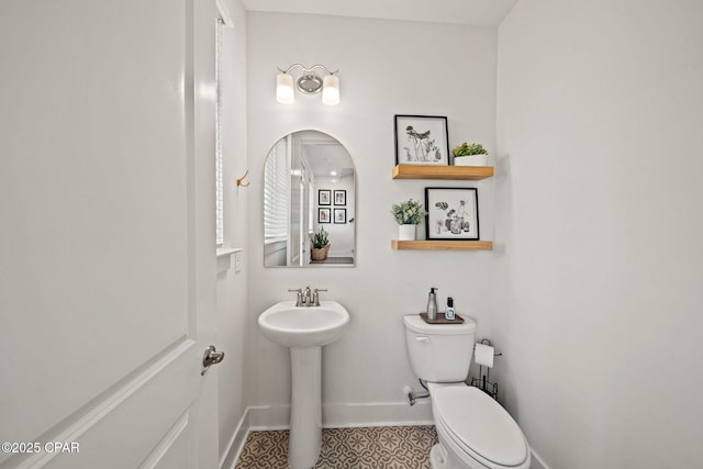 1009 N Discovery Loop, Panama City, FL 32405 - bathroom with baseboards, toilet, a sink, and tile patterned flooring