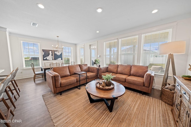 1009 N Discovery Loop, Panama City, FL 32405 - living area with a chandelier, wood finished floors, baseboards, ornamental molding, and recessed lighting