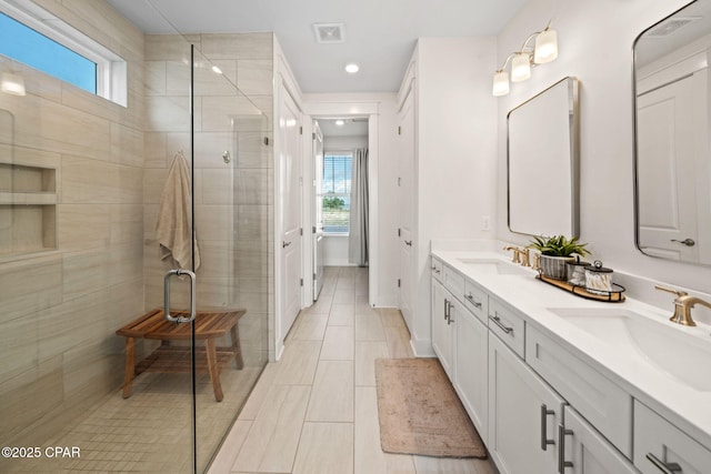 1009 N Discovery Loop, Panama City, FL 32405 - bathroom featuring double vanity, a shower stall, healthy amount of natural light, recessed lighting, and tile patterned flooring