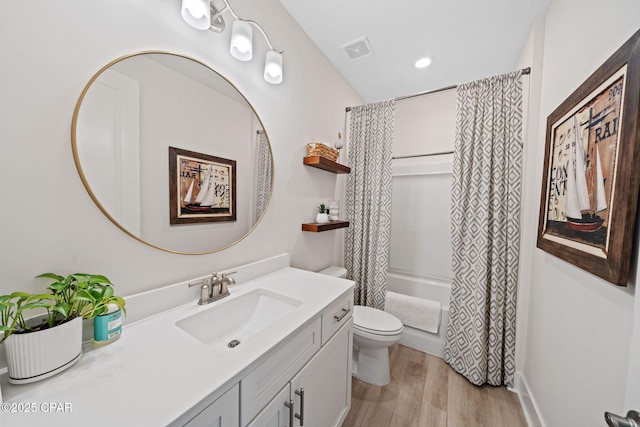 1009 N Discovery Loop, Panama City, FL 32405 - full bath featuring vanity, toilet, shower / bath combo with shower curtain, and wood finished floors