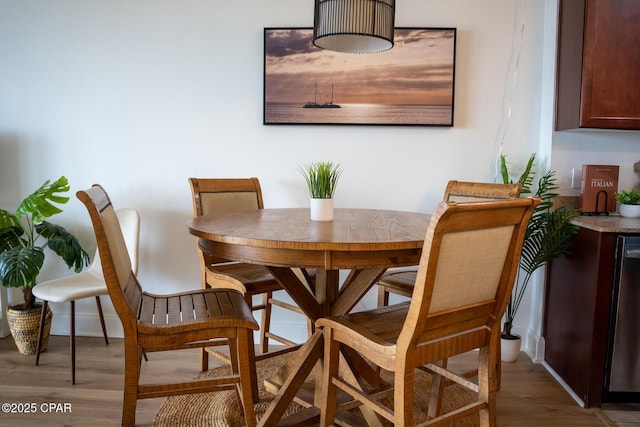 dining space with light wood-type flooring