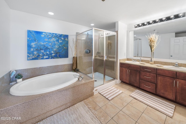 full bathroom with tile patterned floors, a bath, a shower stall, double vanity, and recessed lighting