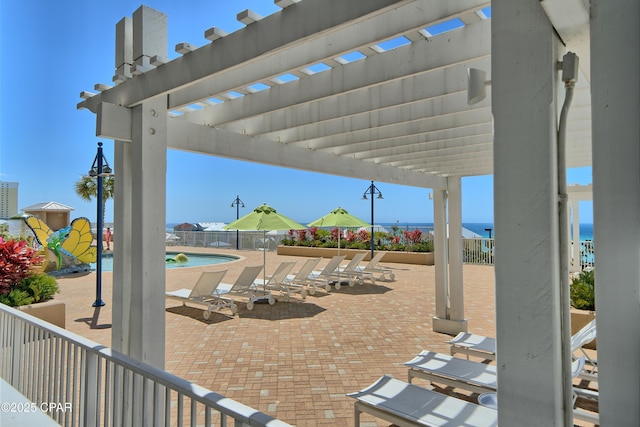 view of patio / terrace featuring a pergola, a community pool, and fence