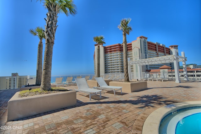 view of swimming pool featuring a pergola, a patio, and fence
