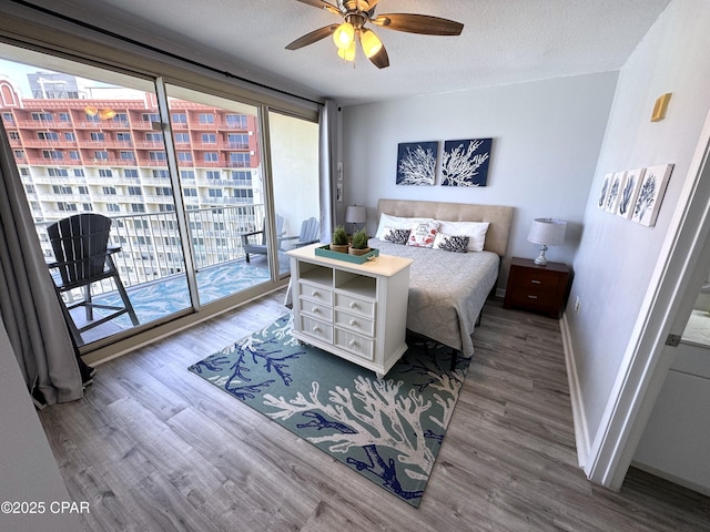 9900 S Thomas Dr Unit 2023, Panama City Beach, FL 32408 - bedroom with multiple windows, access to exterior, wood finished floors, and baseboards