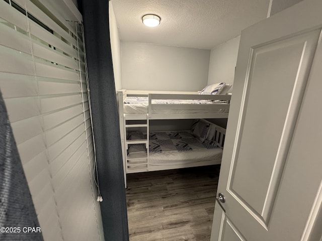 9900 S Thomas Dr Unit 2023, Panama City Beach, FL 32408 - bedroom with wood finished floors and a textured ceiling