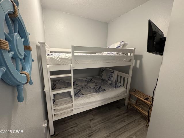9900 S Thomas Dr Unit 2023, Panama City Beach, FL 32408 - bedroom featuring wood finished floors and a textured ceiling