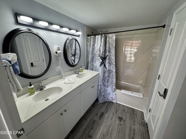 9900 S Thomas Dr Unit 2023, Panama City Beach, FL 32408 - bathroom featuring wood finished floors, shower / bath combo with shower curtain, double vanity, and a chandelier
