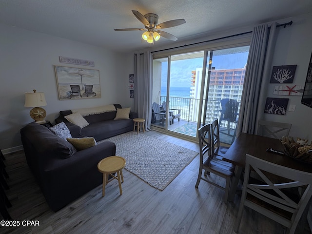 9900 S Thomas Dr Unit 2023, Panama City Beach, FL 32408 - living area with wood finished floors, ceiling fan, and a water view