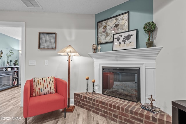 4724 Bylsma Cir, Panama City, FL 32404 - living area with wood finished floors and a brick fireplace