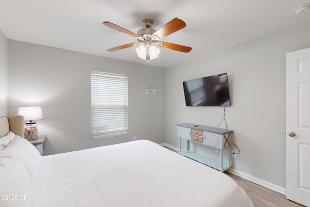 6128 Loquat St, Panama City Beach, FL 32408 - bedroom with light wood finished floors, baseboards, and ceiling fan