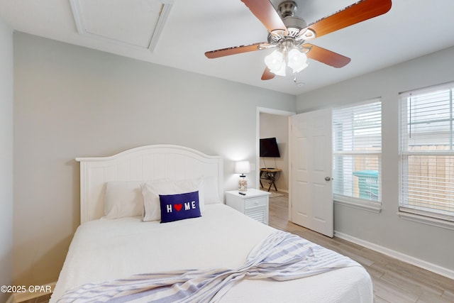 6128 Loquat St, Panama City Beach, FL 32408 - bedroom with light wood-type flooring, a ceiling fan, and baseboards