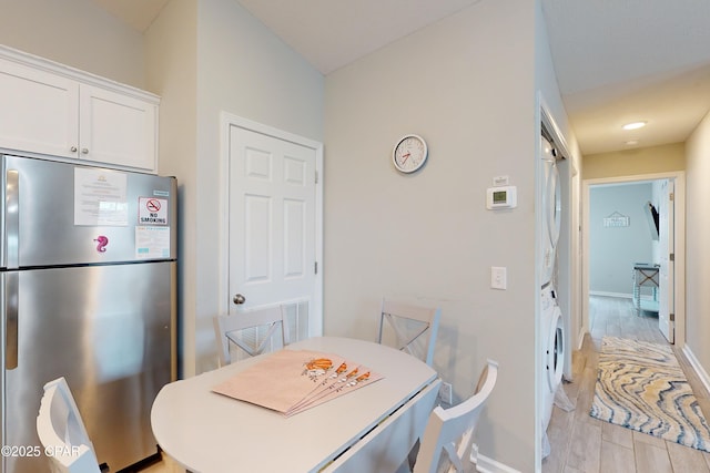 6128 Loquat St, Panama City Beach, FL 32408 - dining area with baseboards and stacked washer and clothes dryer