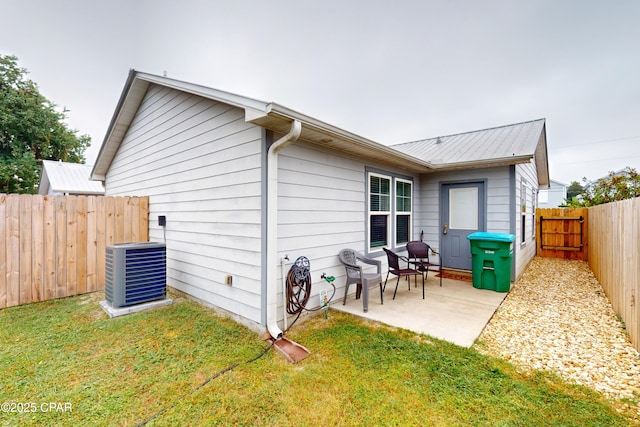 6128 Loquat St, Panama City Beach, FL 32408 - rear view of property with a patio, central AC, and metal roof