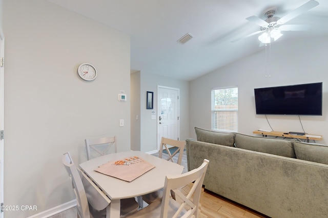 6128 Loquat St, Panama City Beach, FL 32408 - dining space featuring light wood finished floors, vaulted ceiling, a ceiling fan, and baseboards