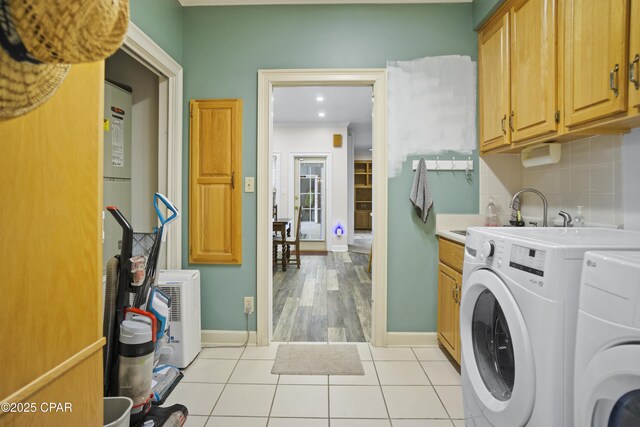 16532 SW Mimosa St, Blountstown, FL 32424 - laundry room with cabinet space, light tile patterned floors, baseboards, washer and clothes dryer, and recessed lighting