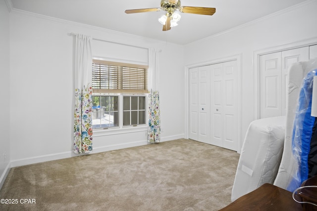 16532 SW Mimosa St, Blountstown, FL 32424 - unfurnished bedroom featuring carpet flooring, crown molding, multiple closets, baseboards, and a ceiling fan